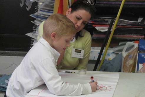 Dr. Lynn Bryan with student coloring