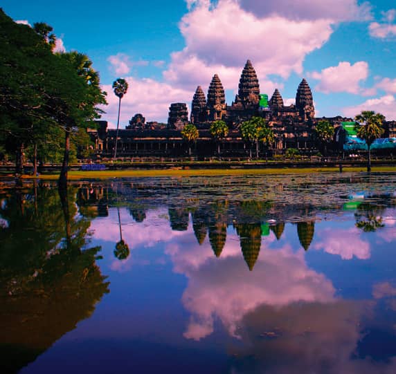 Ruins of Angor Wat at sunset reflecting on the water