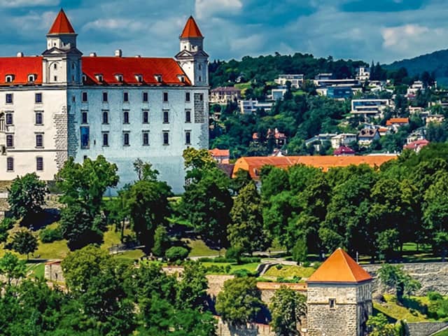 Bratislava Castle with its white façade and red roofs seen from a distance